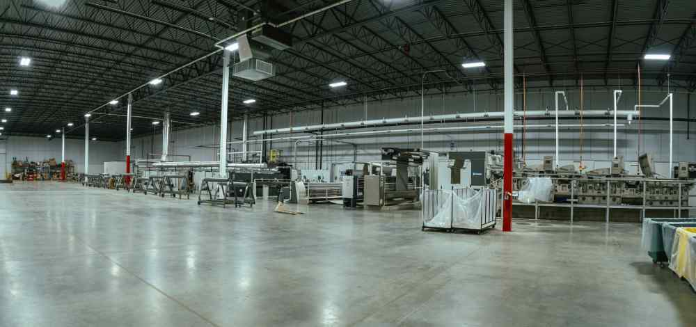 A large warehouse with many machines in it.